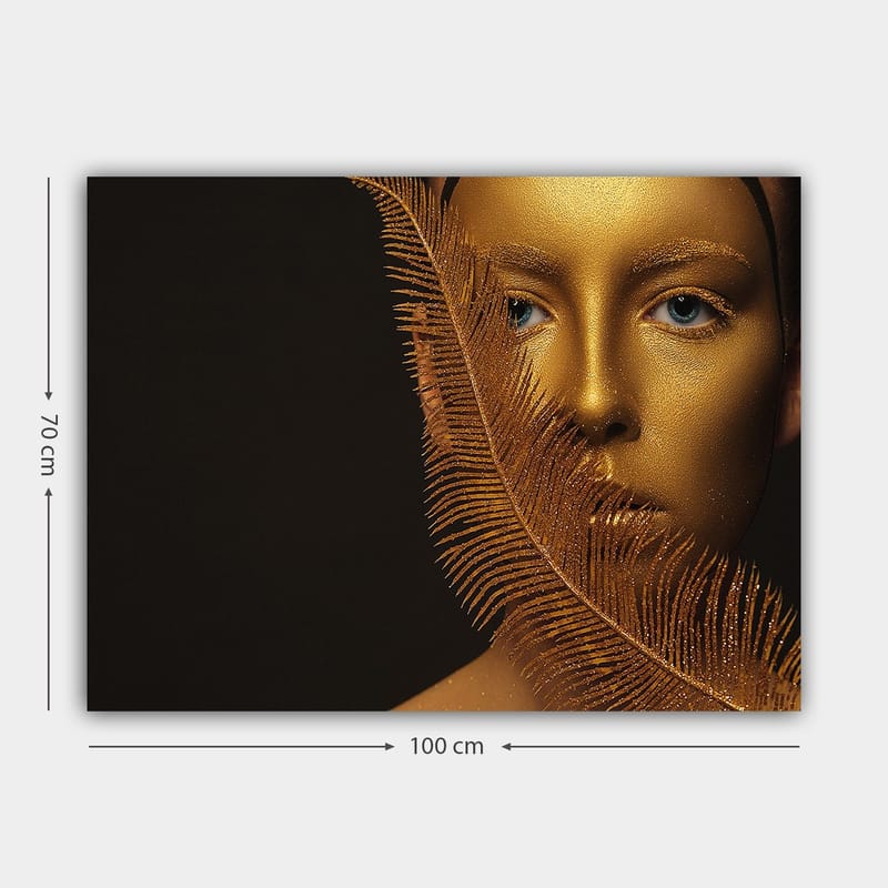 Lerretsbilde 70x100 cm - Ansiktsportrett med gyllen overflate og blå øyne, omgitt av en dekorativ fjærlignende struktur - Gull / Blå - Innredning - Bilder & kunst - Lerretsbilder