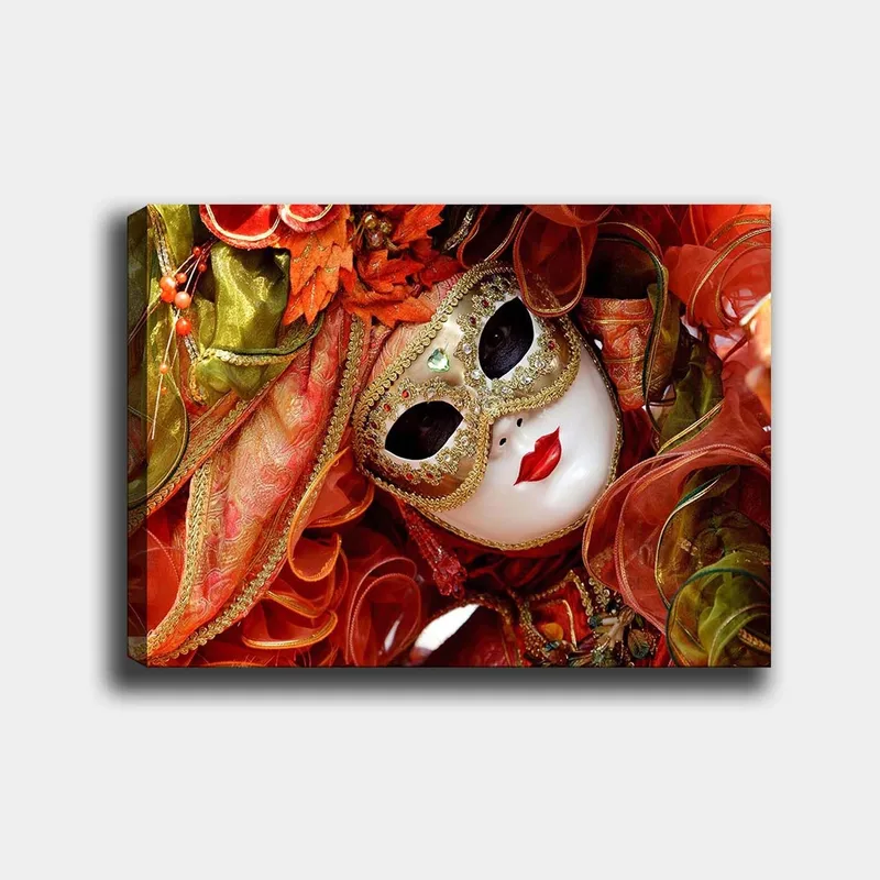 Lerretsbilde 70x100 cm - Elegant maskeradefigur med utsmykket maske og fargerikt kostyme, Rød / Oransje / Grønn