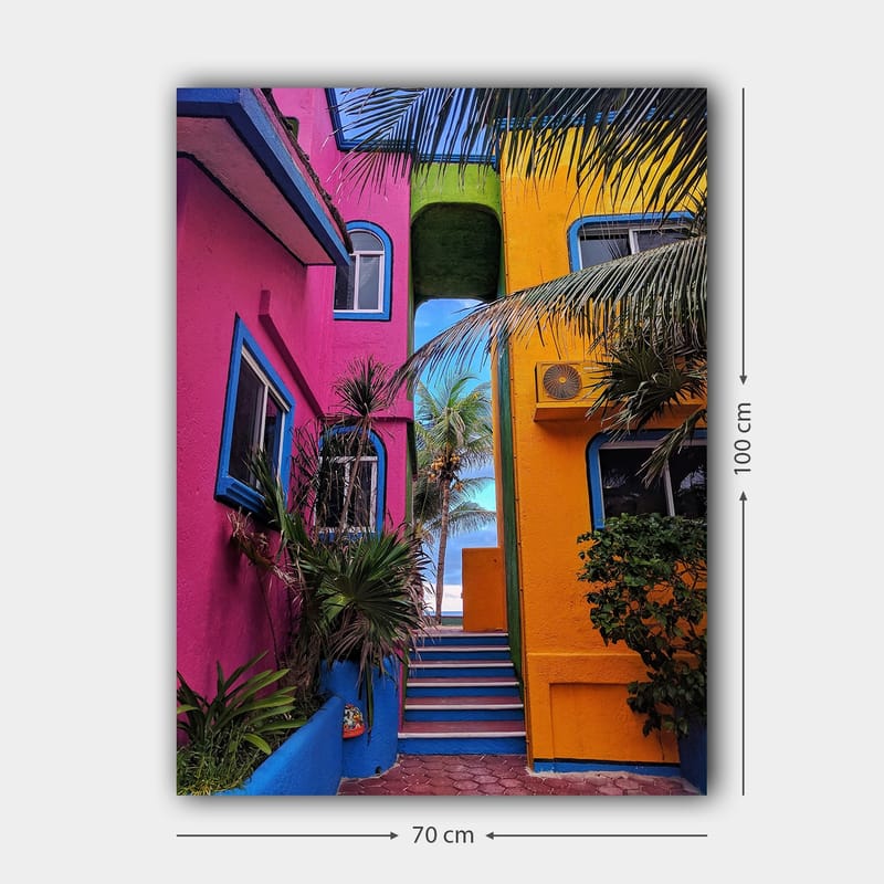 Lerretsbilde 70x100 cm - Fargerik arkitektur med en trapp som fører gjennom en livlig smug - Rosa / Gul / Blå - Innredning - Bilder & kunst - Lerretsbilder