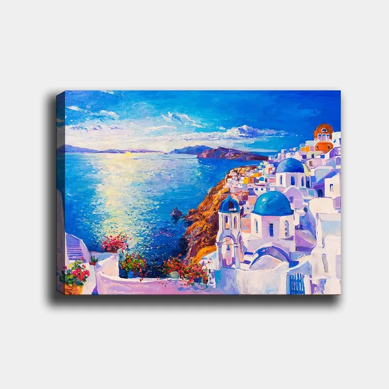 Lerretsbilde 70x100 cm - Fargerik utsikt over en gresk kystby med hvite bygninger og blå kupler som strekker seg mot havet, Blå / Hvit / Oransje