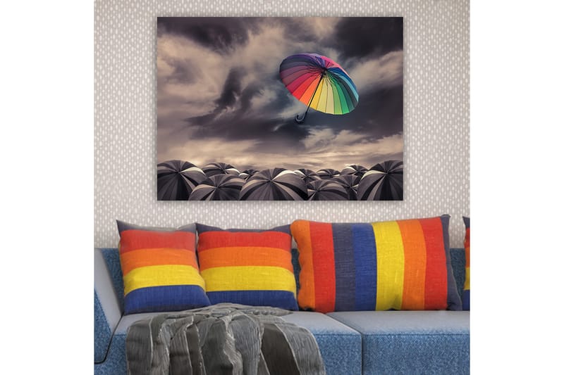 Lerretsbilde 70x100 cm - Fargerik paraply svever over en samling grå paraplyer under en dramatisk overskyet himmel - Regnbuefarger / Grå - Innredning - Bilder & kunst - Lerretsbilder