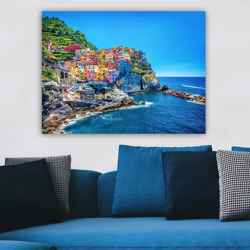 Lerretsbilde 70x100 cm - Fargerike hus som klatrer opp en klippe ved havet - Blå / Gul / Rosa - Innredning - Bilder & kunst - Lerretsbilder