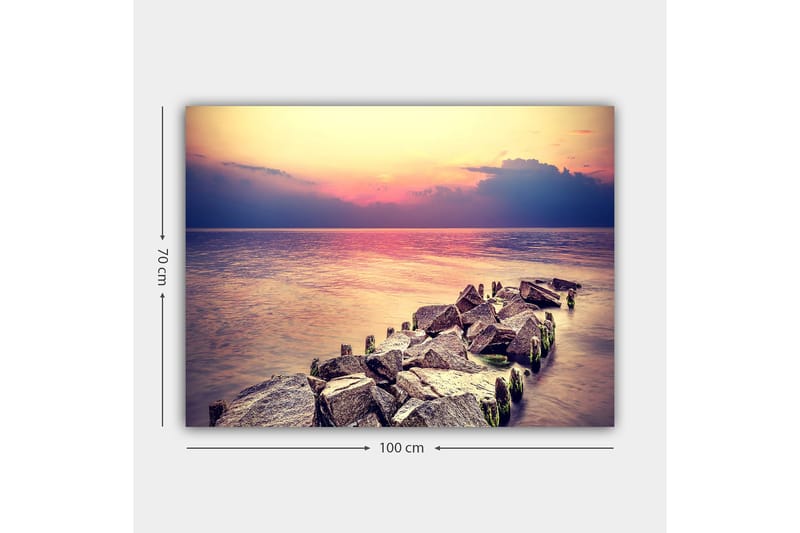 Lerretsbilde 70x100 cm - Fredelig utsikt over en steinete kystlinje ved solnedgang - Grå / Lys blå / Rosa - Innredning - Bilder & kunst - Lerretsbilder