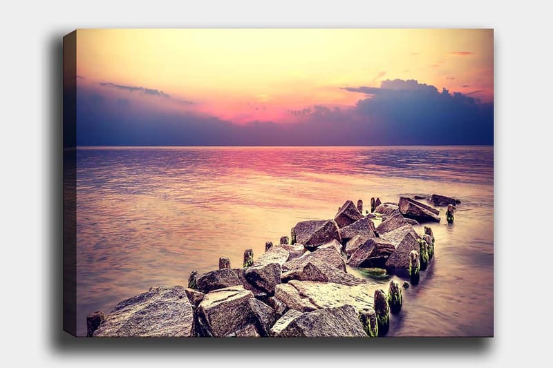 Lerretsbilde 70x100 cm - Fredelig utsikt over en steinete kystlinje ved solnedgang - Grå / Lys blå / Rosa - Innredning - Bilder & kunst - Lerretsbilder