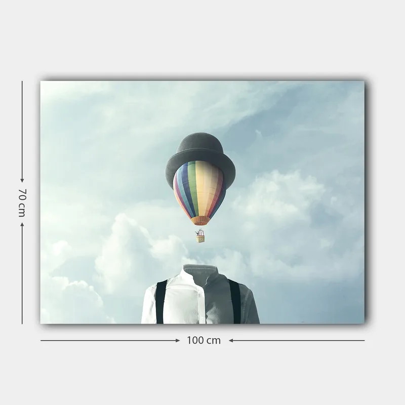 Lerretsbilde 70x100 cm - Hodeløs mann i hvit skjorte og svart hatt, med en fargerik varmluftsballong som svever over seg - Hvit / Svart / Regnbue - Innredning - Bilder & kunst - Lerretsbilder