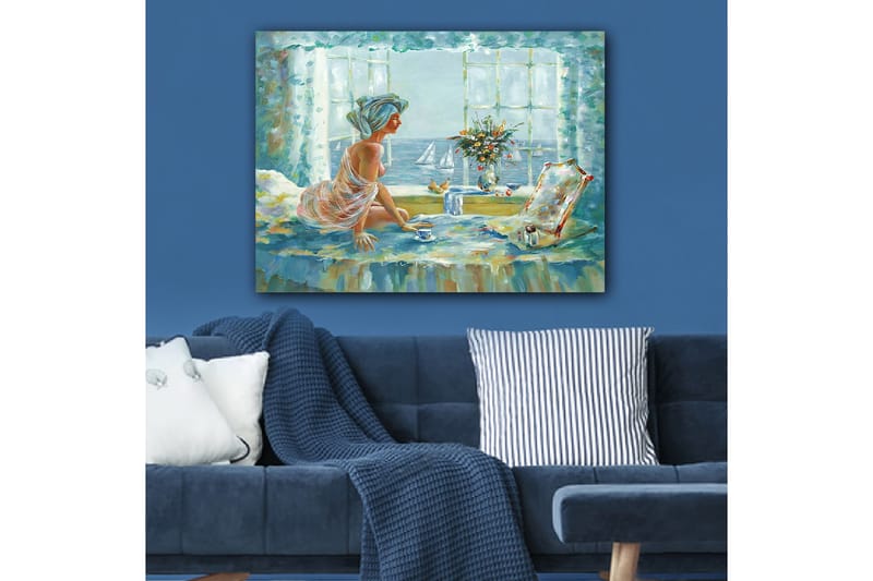 Lerretsbilde 70x100 cm - Kvinne i et lyst og luftig miljø, sittende ved et vindu med utsikt over havet - Blå / Grønn / Beige - Innredning - Bilder & kunst - Lerretsbilder
