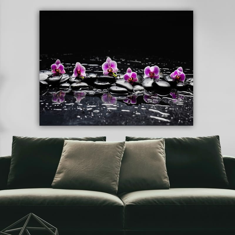 Lerretsbilde 70x100 cm - Rad med lilla orkideer som hviler på svarte steiner med refleksjoner i vann - Lilla / Svart - Innredning - Bilder & kunst - Lerretsbilder