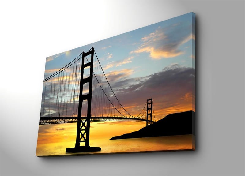 Lerretsbilde 70x100 cm - Silhuett av en bro mot en fargerik solnedgang, Oransje / Svart / Blå