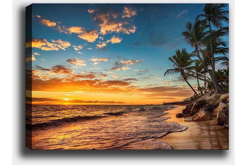 Lerretsbilde 70x100 cm - Vakker solnedgang på en strand med palmer og myke bølger som ruller nedover sanden - Oransje / Blå / Beige - Innredning - Bilder & kunst - Lerretsbilder