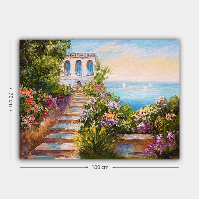 Lerretsbilde 70x100 cm - Vakker trapp omgitt av fargerike blomster som fører ned til havet og en bygning med blå vinduer - Grønn / Rosa / Blå - Innredning - Bilder & kunst - Lerretsbilder