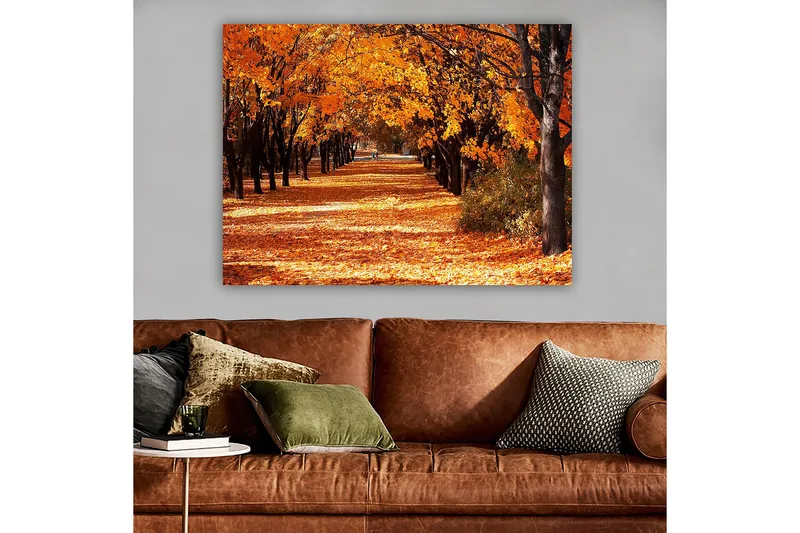 Lerretsbilde 70x100 cm - Vakkert høstmotiv med trær i sterke oransje og gule nyanser som skaper en innbydende gangvei dekket av falne blader - Oransje / Gul / Brun - Innredning - Bilder & kunst - Lerretsbilder