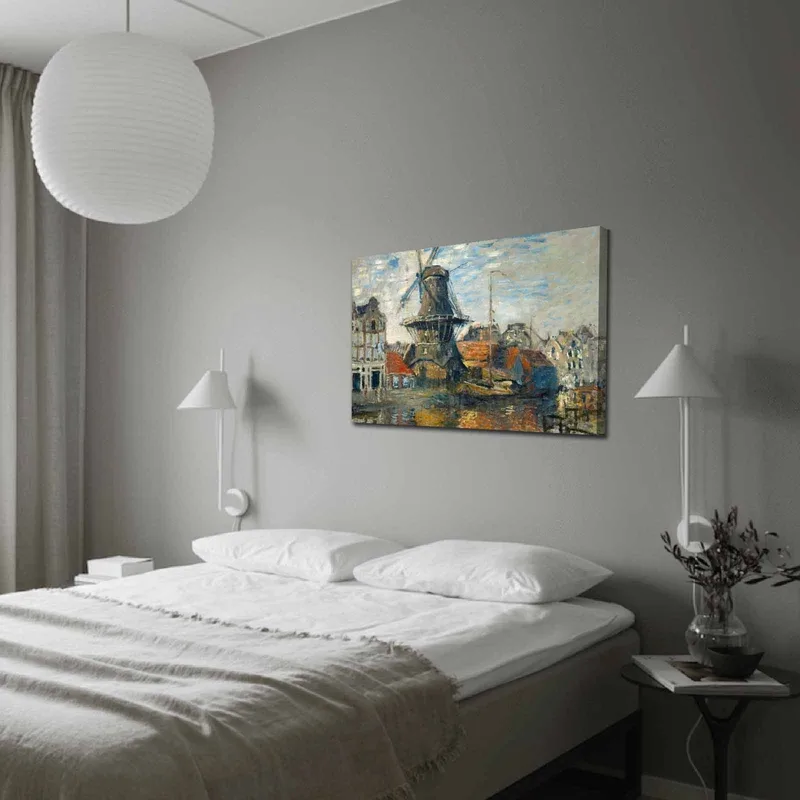 Lerretsbilde 70x100 cm - Vindmølle ved vann omgitt av pittoreske bygninger, Blå / Grønn / Oransje