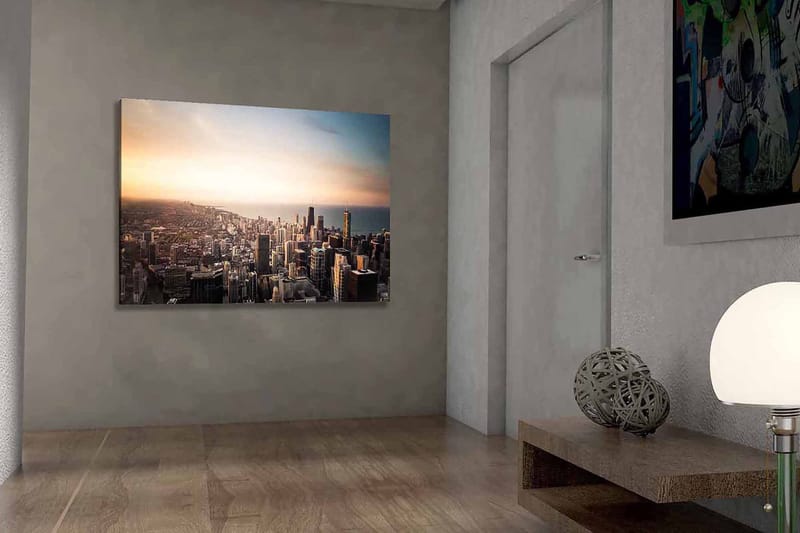 Lerretsbilde 70x100 cm - Panoramautsikt over en by med høye skyskrapere og en solnedgang som skaper en dramatisk atmosfære - Blå / Oransje / Grå - Innredning - Bilder & kunst - Lerretsbilder