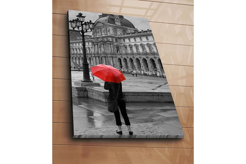 Lerretsbilde 70x100 cm - Person som står med en rød paraply i et regnfullt bymiljø foran en historisk bygning - Rød / Svart - Innredning - Bilder & kunst - Lerretsbilder