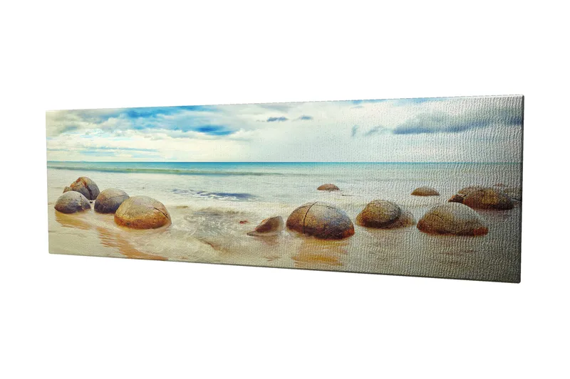 Lerretsbilde 80x30 cm - Runde steiner på en strand med hav og himmel i bakgrunnen - Blå / Beige / Grå - Innredning - Bilder & kunst - Lerretsbilder