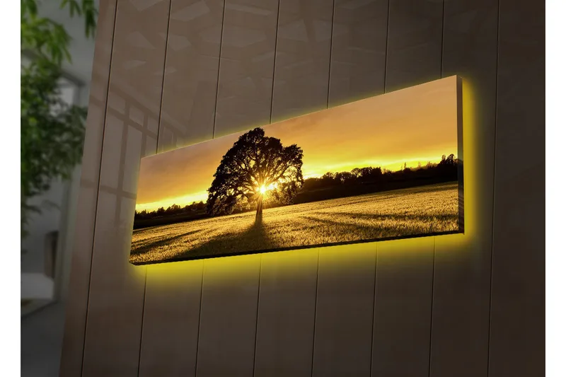 Lerretsbilde med LED-belysning 30x90 cm - Silhuett av et tre mot en gyllen solnedgang, Gull / Svart / Grønn
