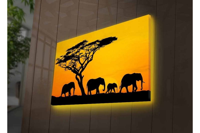 Lerretsbilde med LED-belysning - Silhuetter av elefanter under en solnedgang med et tre i bakgrunnen - Svart / Oransje / Gul - Innredning - Bilder & kunst - Lerretsbilder